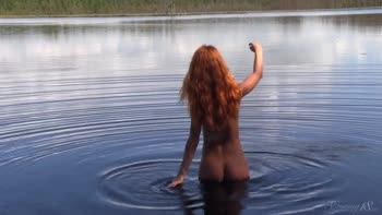 Lily's Sunny Seduction: A Natural Redhead Unfolds by the Water