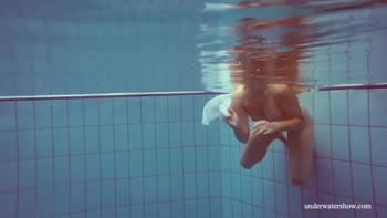 Melisa's Submerged Seduction: Petite Redhead's Underwater Solo