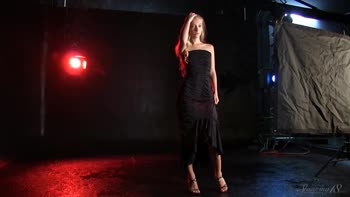 Blonde Beauty Struts in Seductive Black Dress