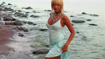 Sultry Blonde Stuns at Beach in Necklace and Nothing More