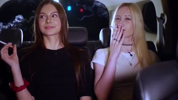 Two Women Smoking and Chatting in a Car at Night